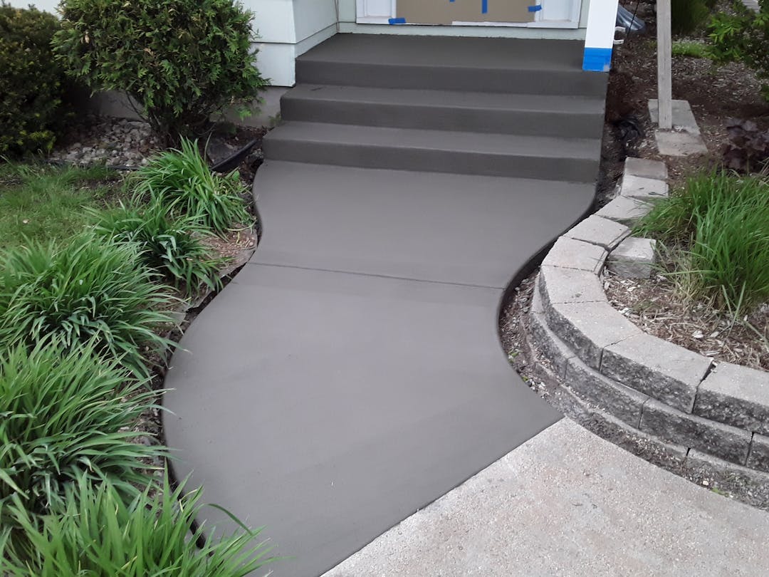 picture of a front concrete walkway for a residential home